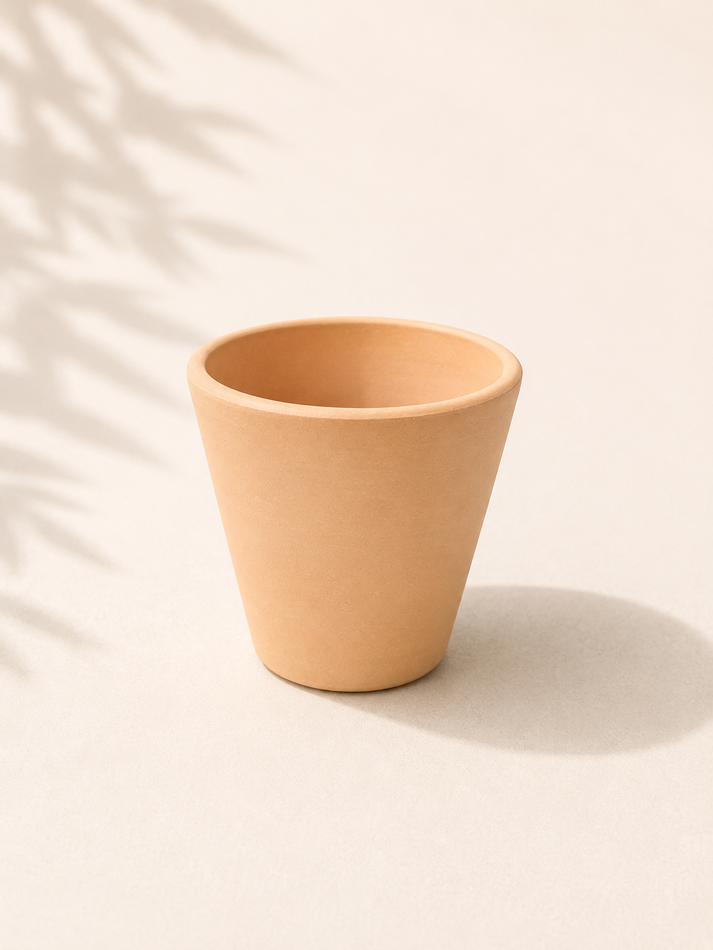 4 inch Vietnamese terracotta cone planter with a warm natural clay finish and tapered handmade shape