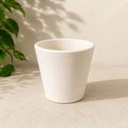 4 inch white Vietnamese terracotta cone planter with a tapered handmade clay shape on a neutral stone surface